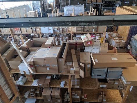 warehouse filled with stacked packages and parcels organized on shelves